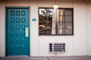 front of a house with windows and teal color front door