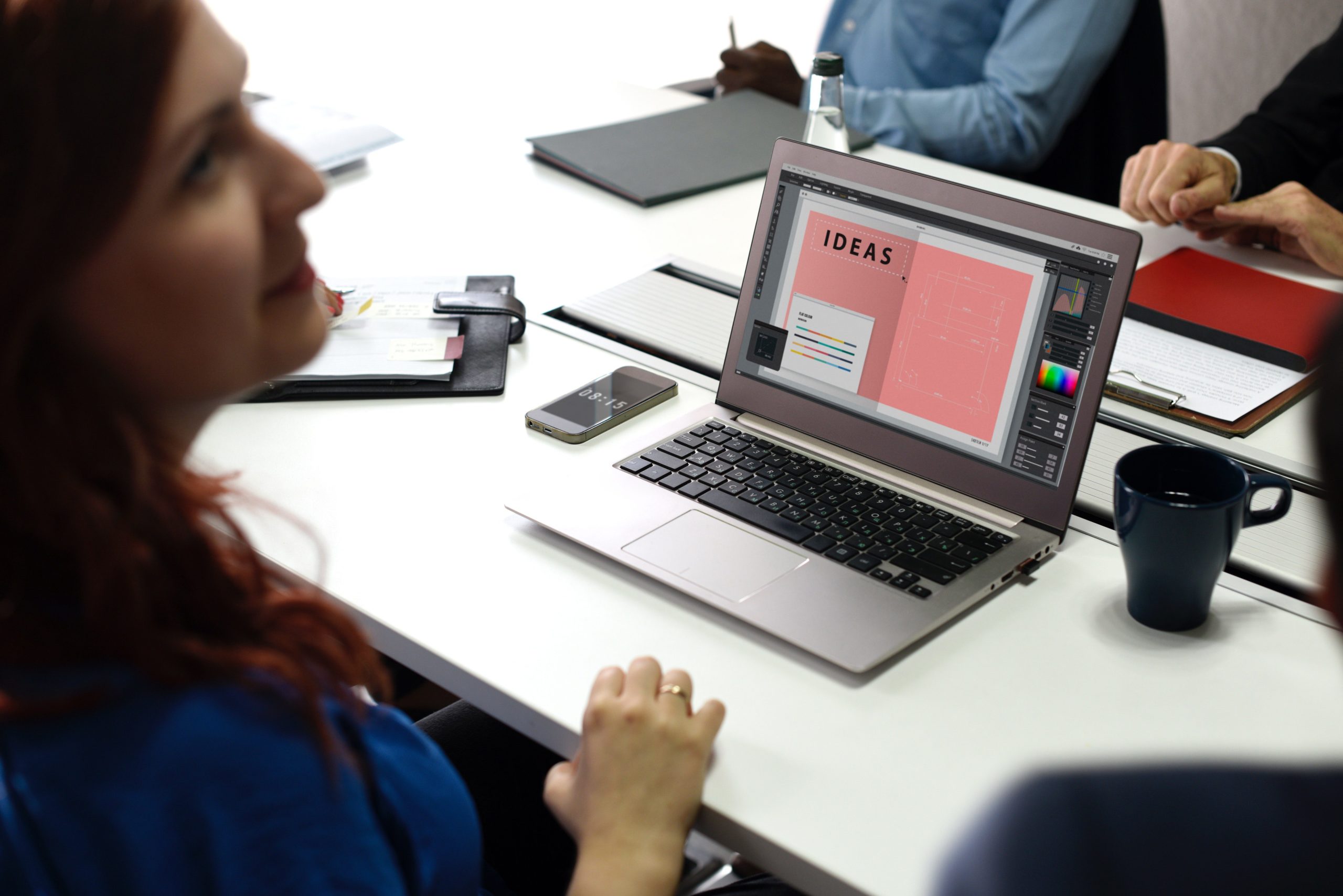 A young woman creates a presentation of ideas on her laptop, an example of a Hoffman Realty client seeking ideas around storm advice